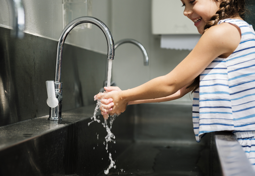 Girl washing her hands